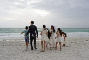 Family beach photography session at sunset on Anna Maria Island with Gulf of America backdrop